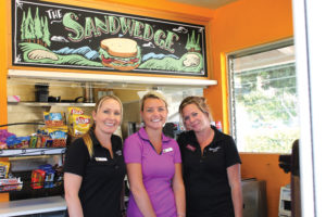 The Sandwedge at Pala Mesa Resort has an order window in the front and a small kitchen in the back, which houses a small prep space, grill, a hot dog roller, and two refrigerators. 