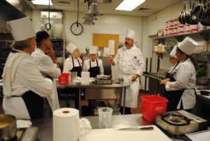 Belfair’s eight-week cooking school, led by Executive Chef Bruce Christensen, CEC, CCA (center), teaches culinary basics.