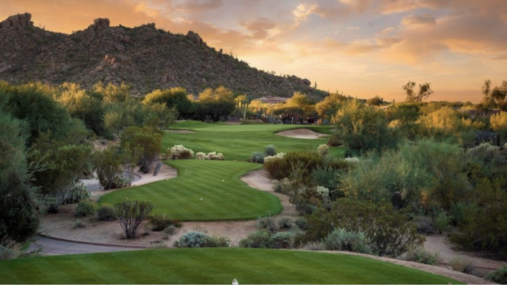 golf course with sun setting over mountain