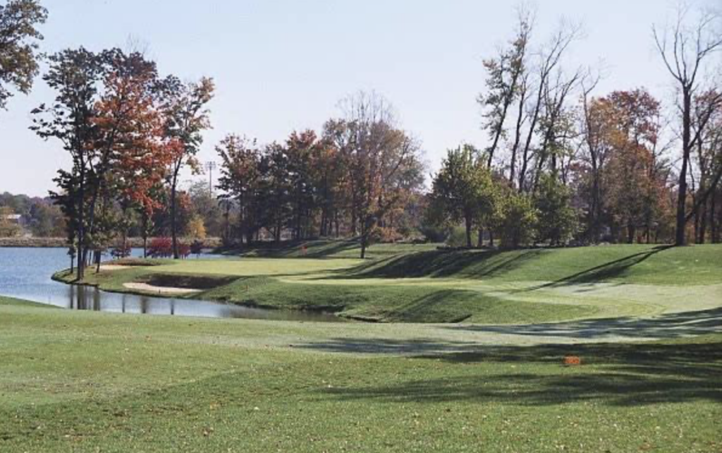 golf course green with water on the left