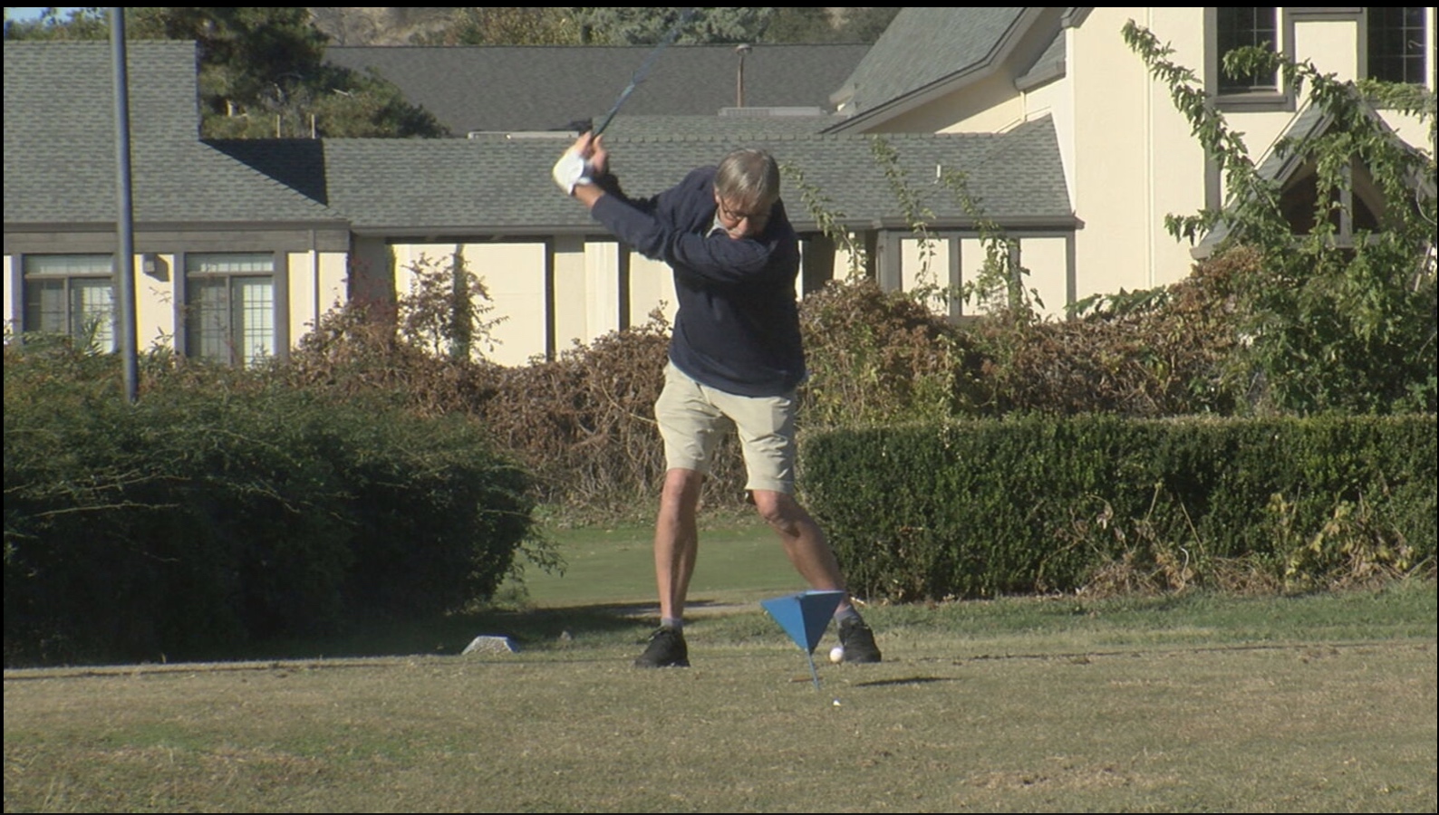 golfer tees off