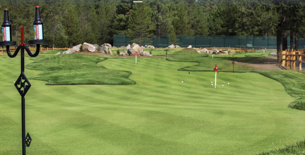 Putting course with two bottles of beer.
