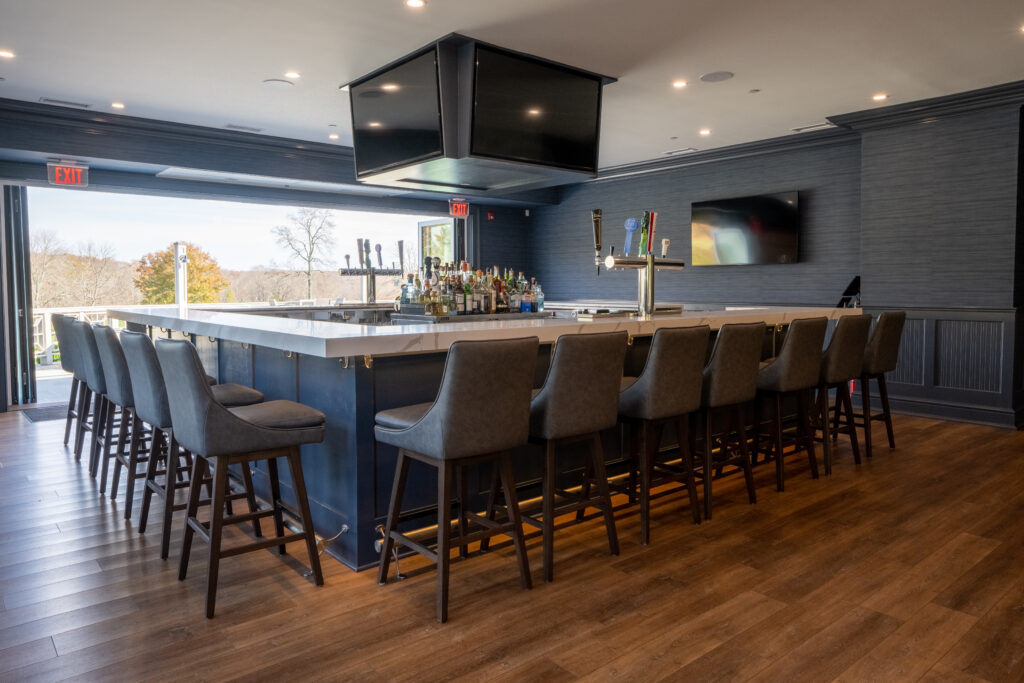 Bar with stools and TVs.